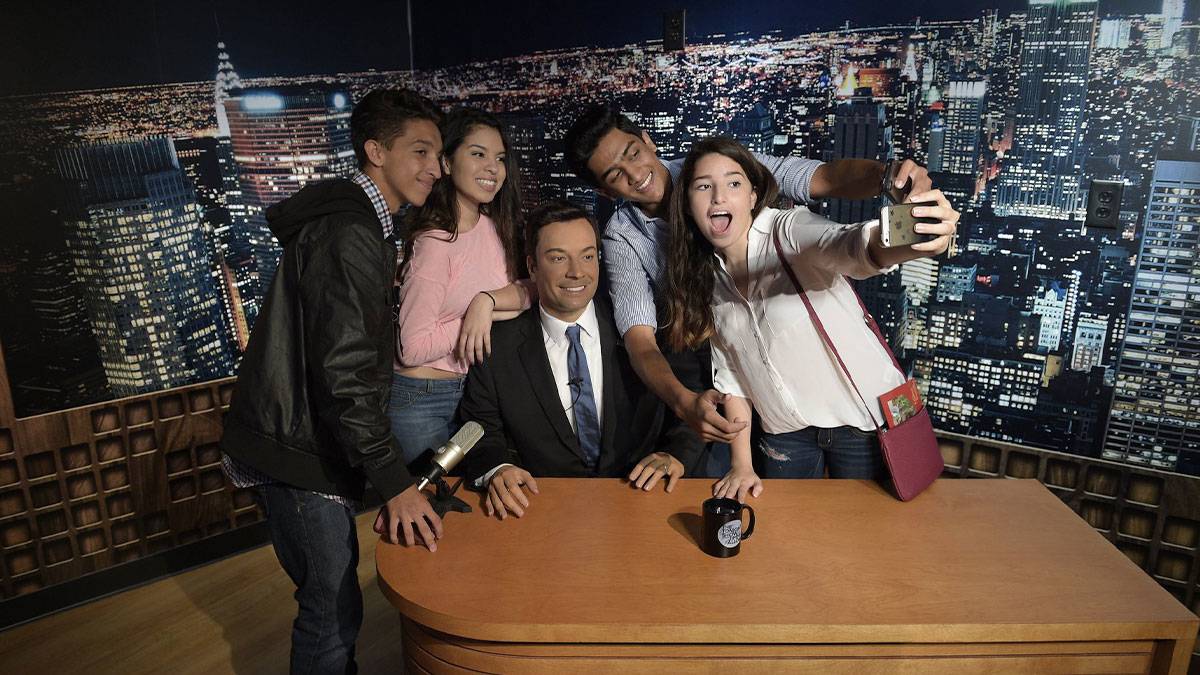 a group of friends getting a picture with a celebrity